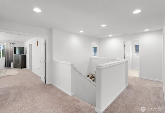 Upstairs you'll find a bright and open landing with French doors leading to the Primary Suite + 3 additional bedrooms, a bonus room, and laundry room! | Image 18
