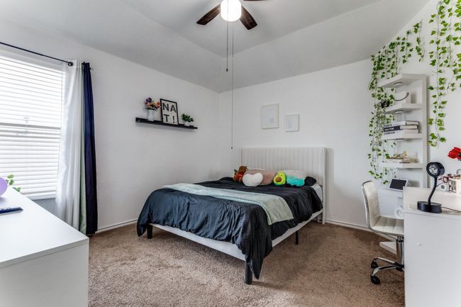 Bedroom with carpet flooring and a ceiling fan | Image 27