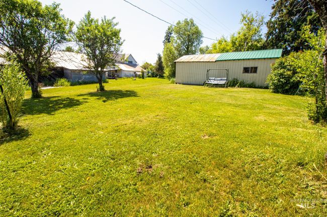 View of green lawn with a pole building and an outbuilding | Image 5