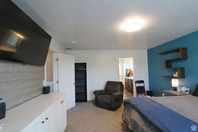 Bedroom with light colored carpet and ensuite bathroom | Image 16