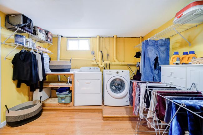 Laundry area featuring wood finished floors, laundry area, and washer and clothes dryer | Image 37