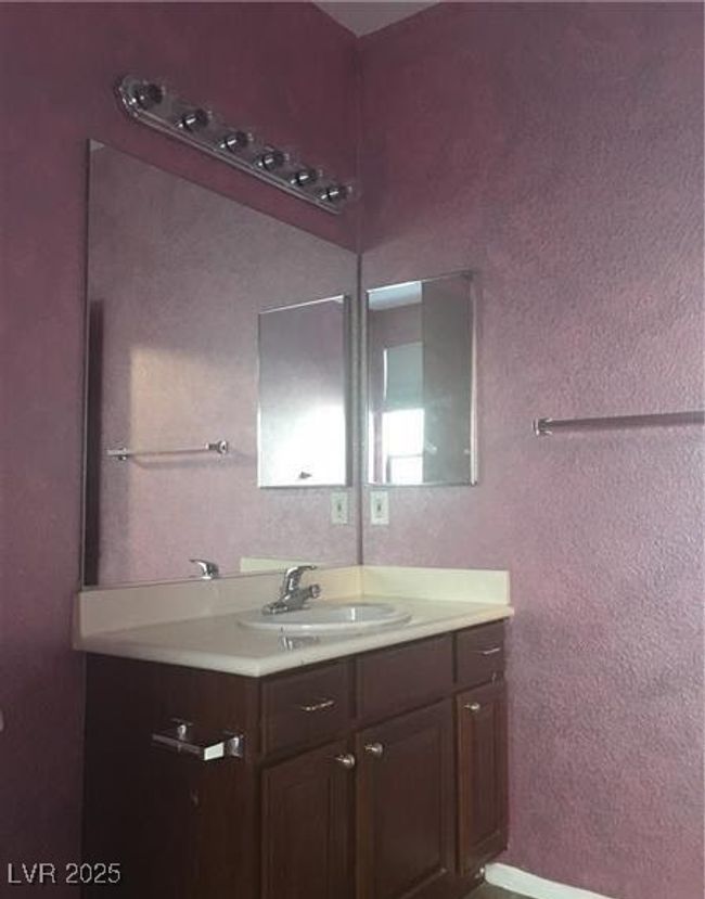 Bathroom featuring vanity and a textured wall | Image 13
