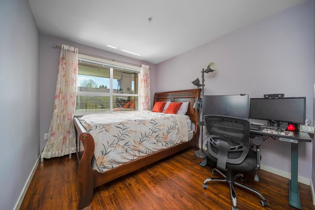 Bedroom with baseboards and wood finished floors | Image 17