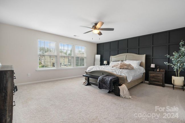 Primary bedroom features ceiling fan, lots of natural light, custom made feature wall behind bed! | Image 28