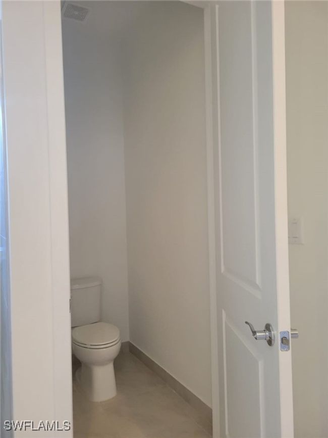 Bathroom featuring toilet and baseboards | Image 16