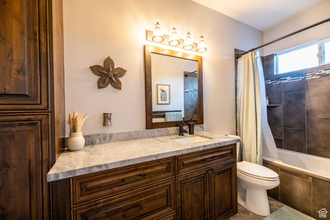 Bathroom featuring vanity and tiled shower / bath combo | Image 64