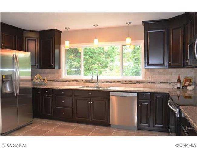 Kitchen - You will not find a better kitchen in a home at this price! The new cabinets, new floor, new stainless steel appliances make this kitchen sparkle! | Image 1