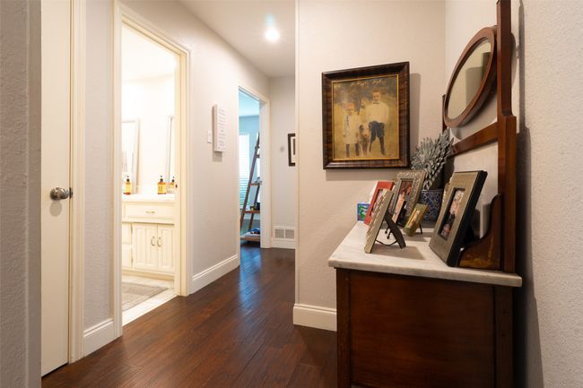 Hallway with dark wood-type flooring, baseboards, and recessed lighting | Image 21