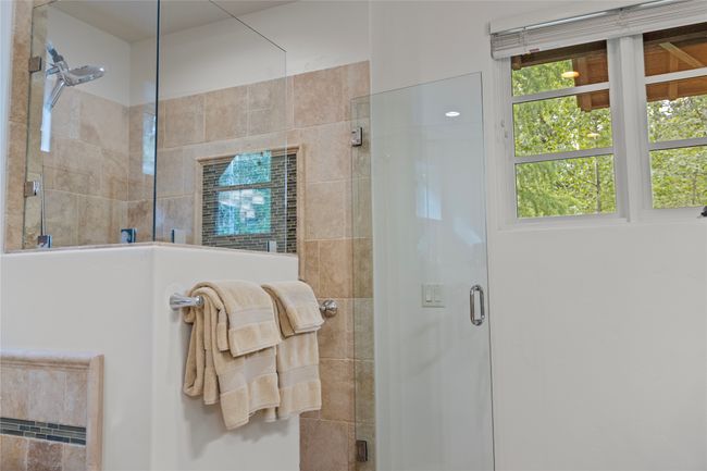 Stone and glass walk-in shower. | Image 40