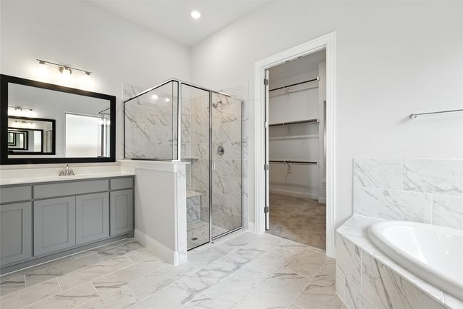 Bathroom featuring a stall shower, a bath, vanity, marble finish flooring, and recessed lighting | Image 20