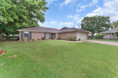 Single story home with a garage and a front yard | Image 1