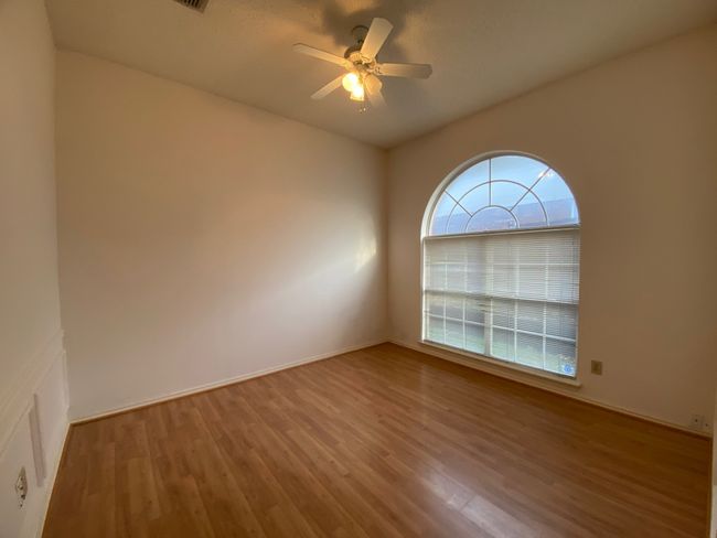Spare room featuring wood finished floors and a ceiling fan | Image 11