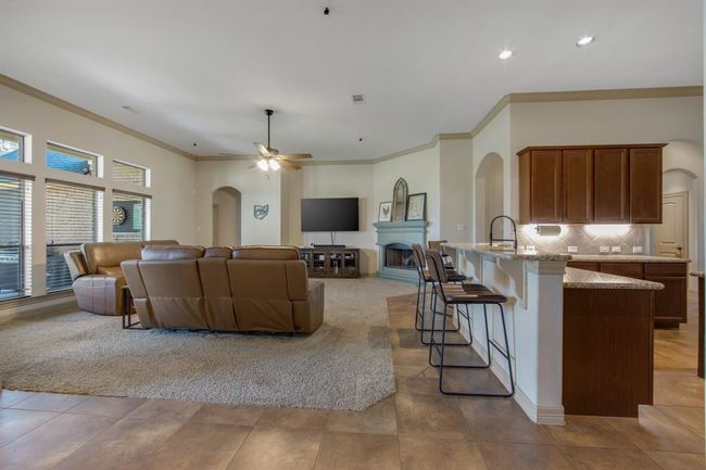 Open floor plan, crown molding, extra wide baseboards, breakfast bar, canister lights... | Image 18