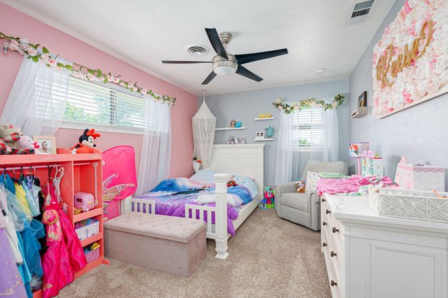 Bedroom with light colored carpet and a ceiling fan | Image 34