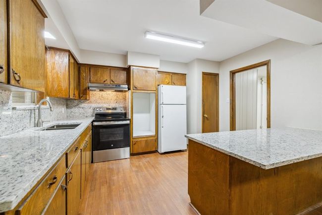 Custom cabinets, lots of storage made with stained solid wood. | Image 13