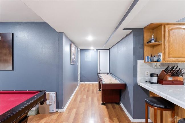 Rec room with light wood finished floors and billiards | Image 6