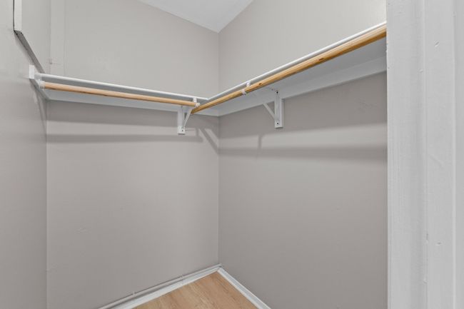 Walk in closet featuring wood finished floors | Image 17