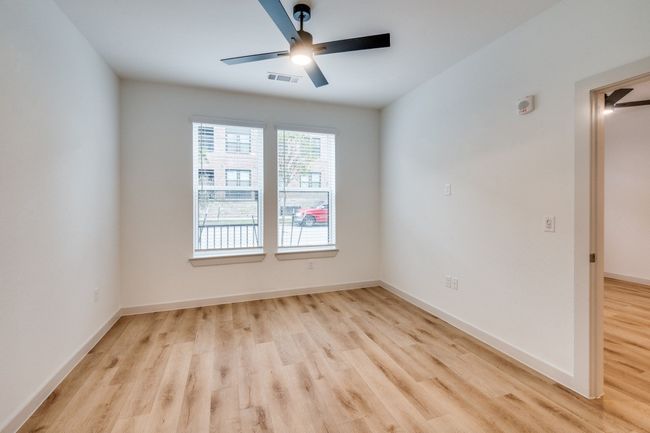 Spare room featuring visible vents, ceiling fan, baseboards, and wood finished floors | Image 18