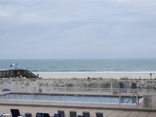 Community pool featuring view of Ocean, beach and Solar Heated Swimming Pool And Patio area | Image 8