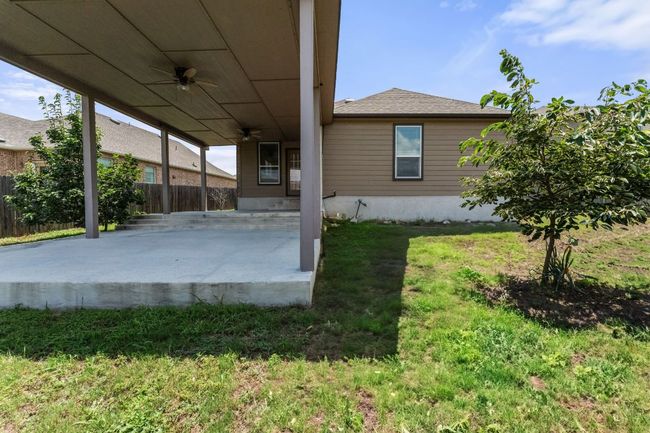 View of yard featuring a ceiling fan and a patio | Image 33