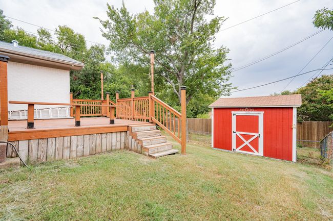 Fenced backyard with a wooden deck and a storage shed | Image 28