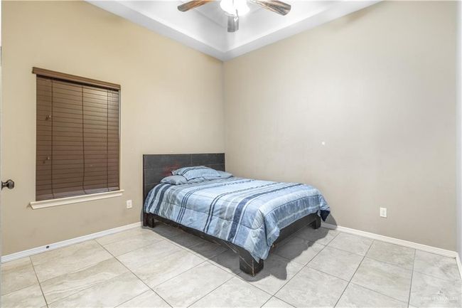 Bedroom with light tile patterned flooring and ceiling fan | Image 15