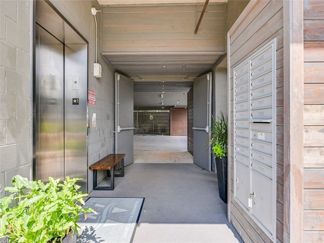 The mailbox kiosk and a bike rack are located on the ground floor of the elevator and stairwell. | Image 34