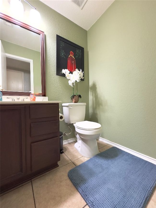 Half bath with vanity, tile patterned floors, and a textured wall | Image 8