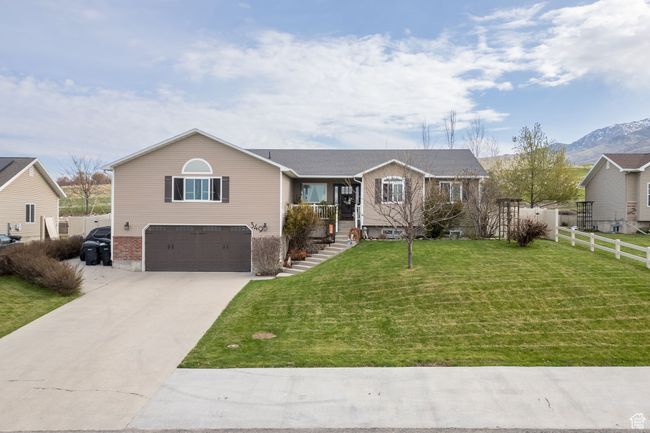 Ranch-style home with a garage, driveway, fence, a mountain view, and a front yard | Image 46
