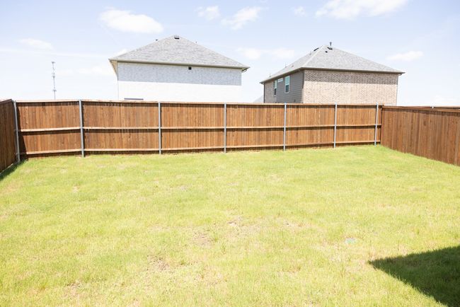 View of fenced backyard | Image 25