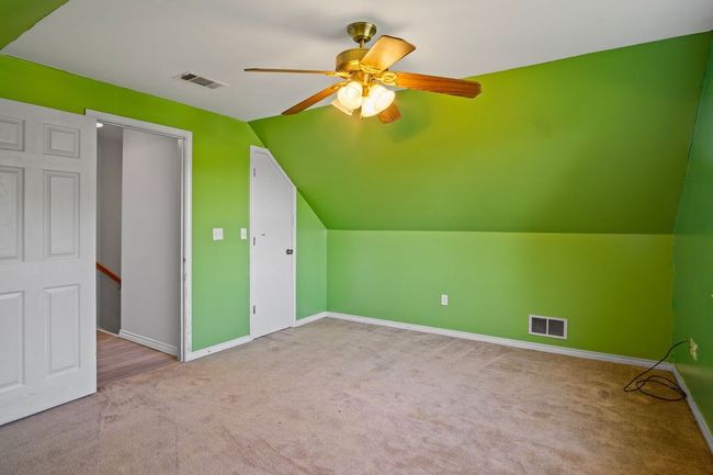 Bonus room featuring a ceiling fan, carpet flooring, and lofted ceiling | Image 22