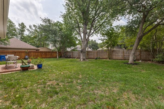 Six-foot wood privacy fence surrounds this beatufiul and functional yard space. | Image 37