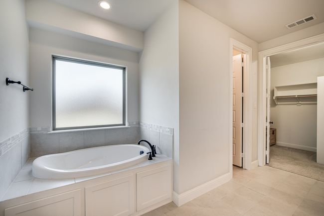 Bathroom featuring a bath and tile patterned floors | Image 19