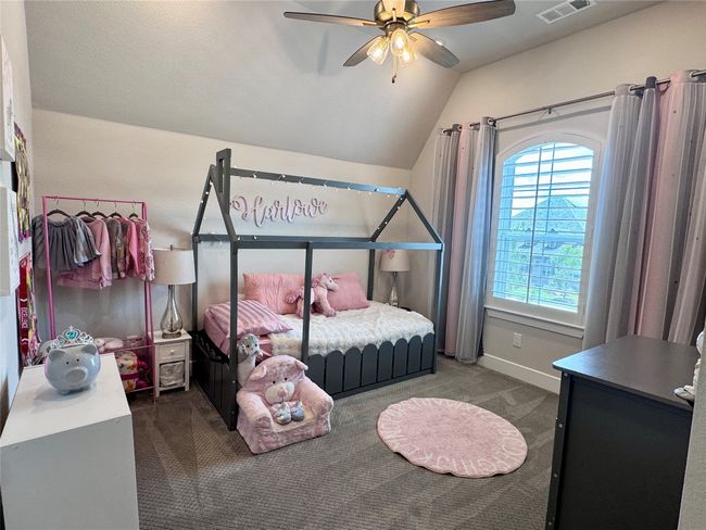 Carpeted bedroom with lofted ceiling and a ceiling fan | Image 32