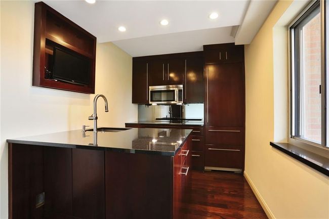 Kitchen with recessed lighting, a sink, stainless steel microwave, dark wood-type flooring | Image 5