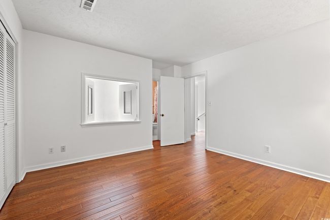 Unfurnished bedroom featuring hardwood / wood-style floors and a closet | Image 25