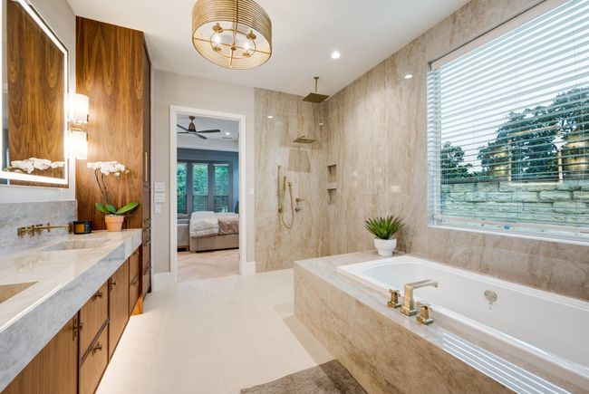 Ensuite bathroom with a bath, double vanity, walk in shower, and a ceiling fan | Image 17