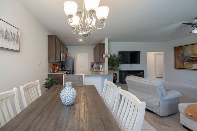 Dining area with a chandelier and ceiling fan | Image 14