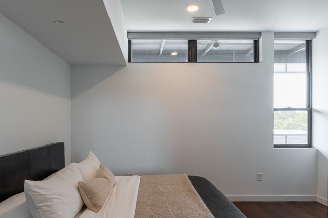 Bedroom with baseboards, visible vents, and dark wood finished floors | Image 17