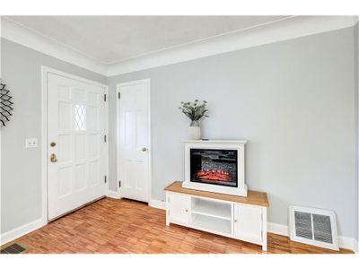 Open wood floored foyer with coat closet | Image 3