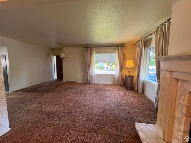 Formal South entrance with coat closet, large living room with gas fireplace, lots of windows and area for formal dining area | Image 10