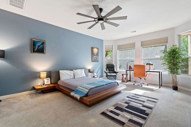 Carpeted bedroom with baseboards, a ceiling fan, and visible vents | Image 22