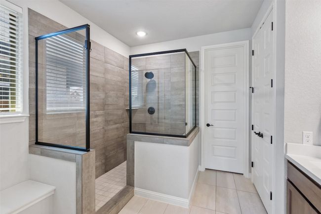 Full bathroom featuring walk in shower, tile patterned flooring, and vanity | Image 19