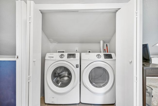 Laundry room featuring laundry area and washing machine and clothes dryer | Image 49