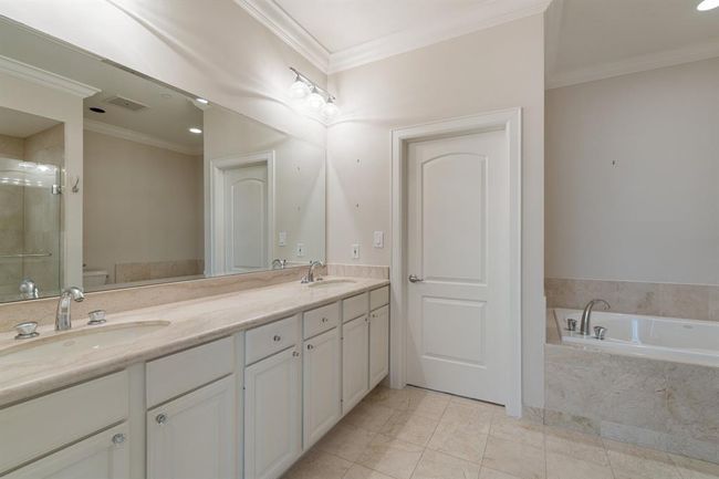 Primary bathroom with double sink vanity, large seamless glass shower and an oversized soaking tub. | Image 26