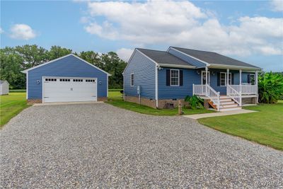 View of front of property with a front lawn, covered porch, and a garage | Image 3