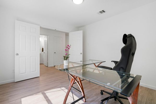 A versatile bedroom on this main level can easily serve as a home office or guest bedroom. | Image 7