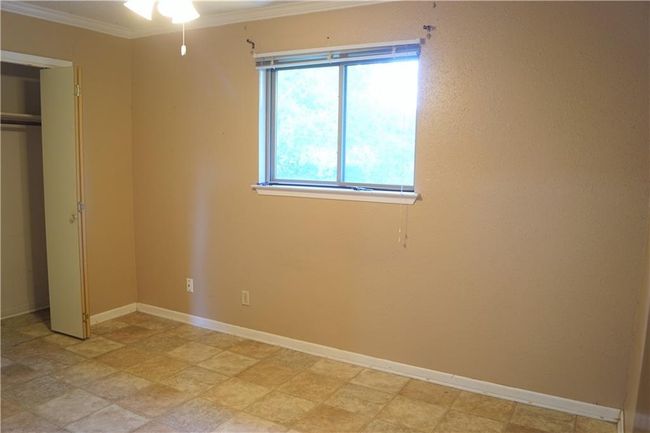Unfurnished bedroom with ornamental molding and a closet | Image 6