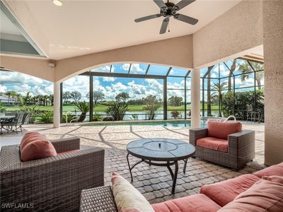 Sunroom featuring ceiling fan, lofted ceiling, and a water view | Image 3