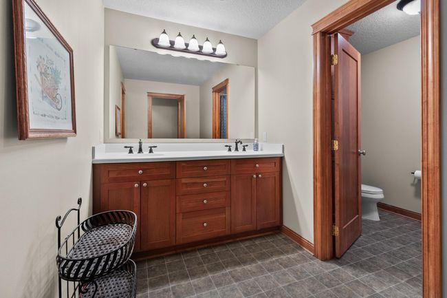 Upper-level full bathroom with dual sinks separate from W.C. and tub/shower area. | Image 33